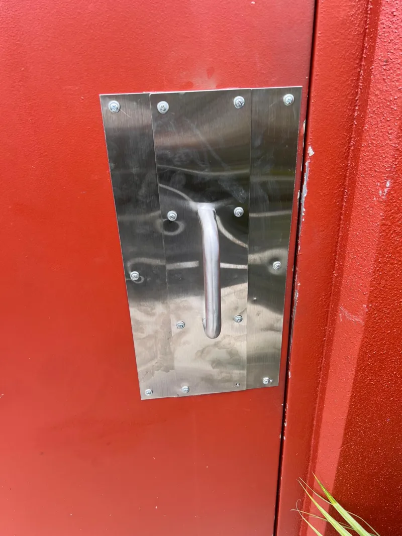 locksmith assessing kicked-in door frame damage after burglary in Stuart FL