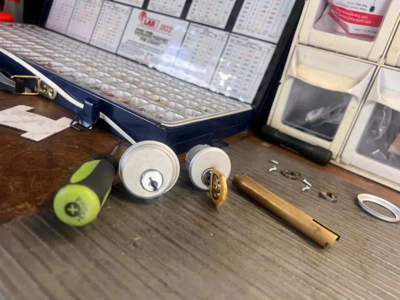 Locksmith comparing lock rekey and lock replacement options for Stuart FL homeowner