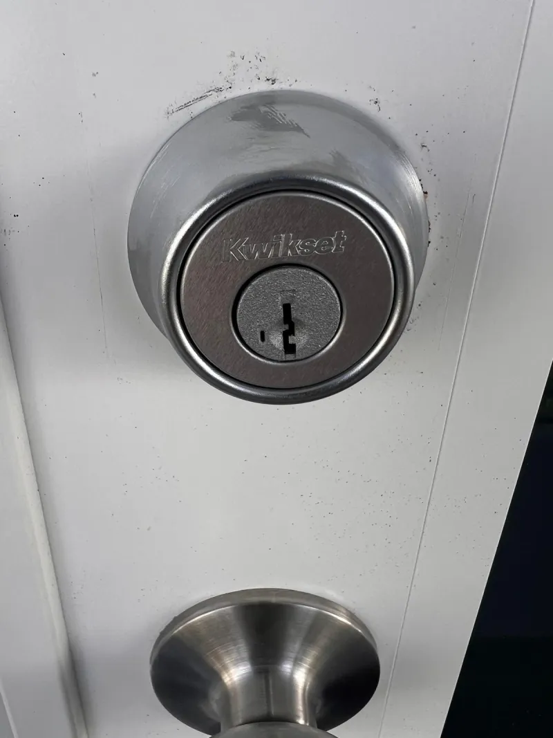 Smart lock being installed on a front door of a new home in Stuart Florida